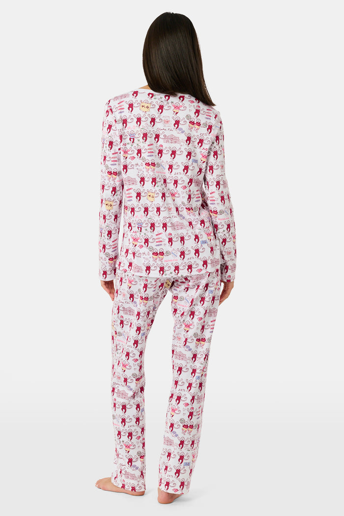 The Alpha Phi Monkey Pajamas by Roller Rabbit are a long-sleeve pajama set crafted from soft Pima cotton, featuring a red and gray cartoon animal print on a white background, with a Henley top and matching pants.