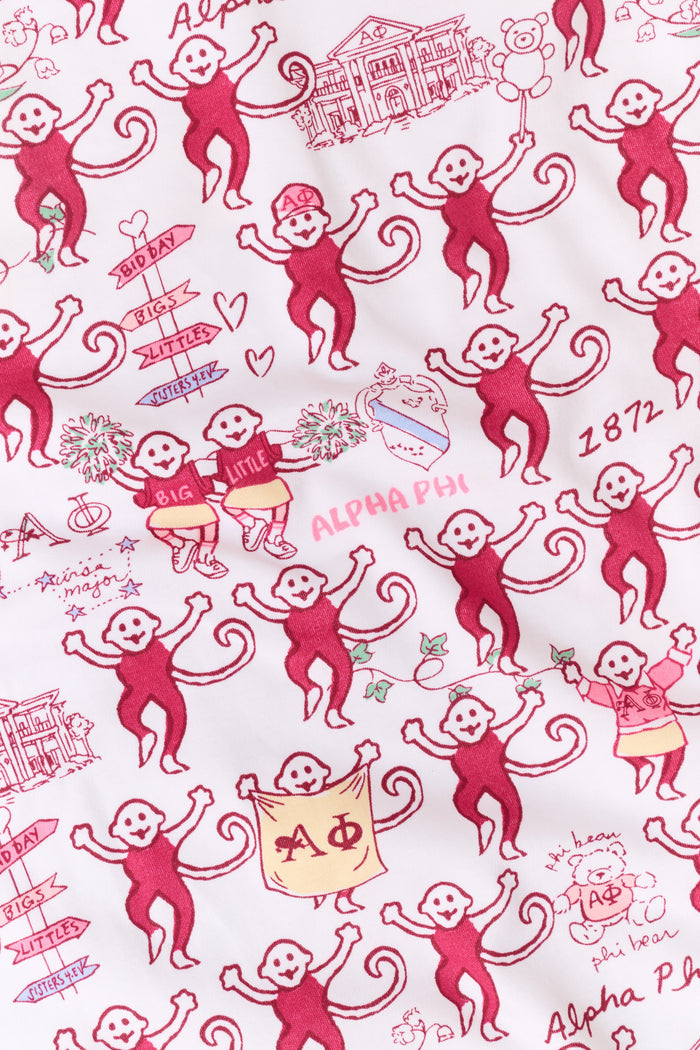 The Alpha Phi Monkey Pajamas by Roller Rabbit are a long-sleeve pajama set crafted from soft Pima cotton, featuring a red and gray cartoon animal print on a white background, with a Henley top and matching pants.