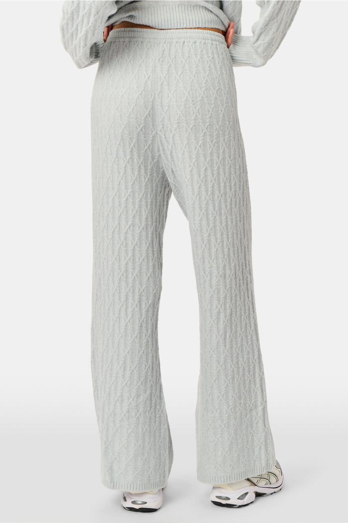 A person wearing the Roller Rabbit Cable Knots Olivia Pant in light gray, featuring a drawstring waist, paired with a matching top and white sneakers. The photo is cropped from shoulders down against a white background.