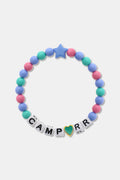 The Roller Rabbit Camp RR Besties Bracelet features pink, blue, and green beads, a blue star bead, white letter beads spelling CAMP R R with a gold-edged green heart as the "O"—a perfect colorful accessory for summer.