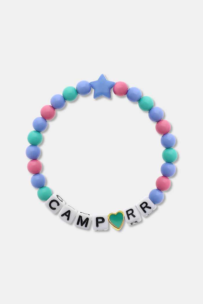 The Roller Rabbit Camp RR Besties Bracelet features pink, blue, and green beads, a blue star bead, white letter beads spelling CAMP R R with a gold-edged green heart as the "O"—a perfect colorful accessory for summer.
