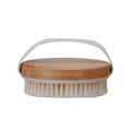 A cherry wood body brush with a fabric handle loop.