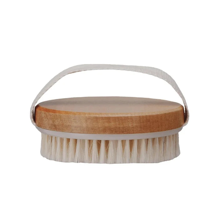 A cherry wood body brush with a fabric handle loop.