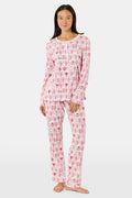 The Roller Rabbit Chi Omega Monkey Pajamas are a long-sleeve Henley top pajama set with matching pants, featuring a white background decorated with red, pink, and gray hearts, XOXO motifs, and playful accents. The pants are designed with a comfortable mid-rise elastic waist.