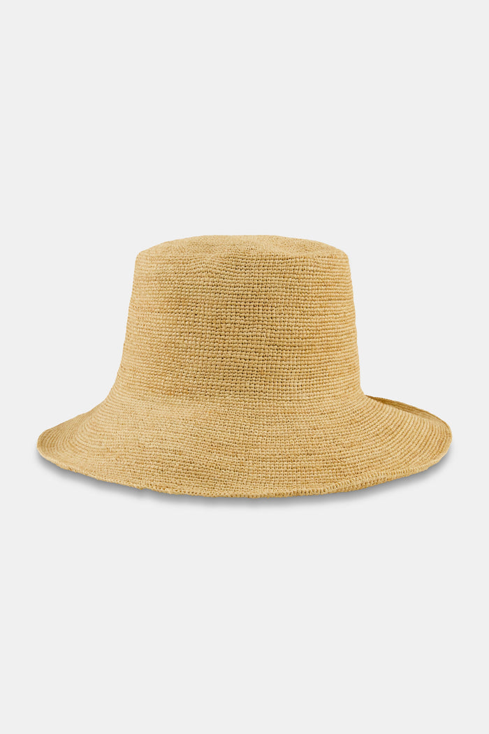 A person with long brown hair is seen from behind wearing the Hat Attack Chic Crochet Bucket Hat and a green top with white patterns against a plain background.