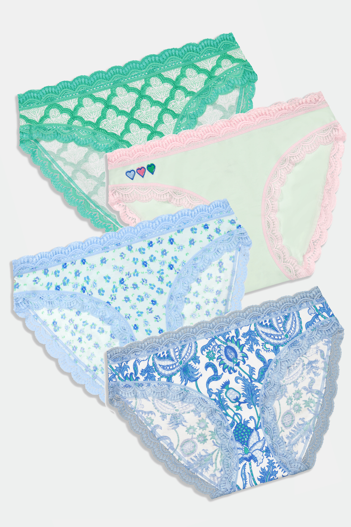 The Classic Core Bikini 4 Pack by Roller Rabbit includes four soft cotton modal panties, each with lace trim: green with hearts, light blue floral, white with blue paisley, and mint green with pink trim and embroidered hearts.
