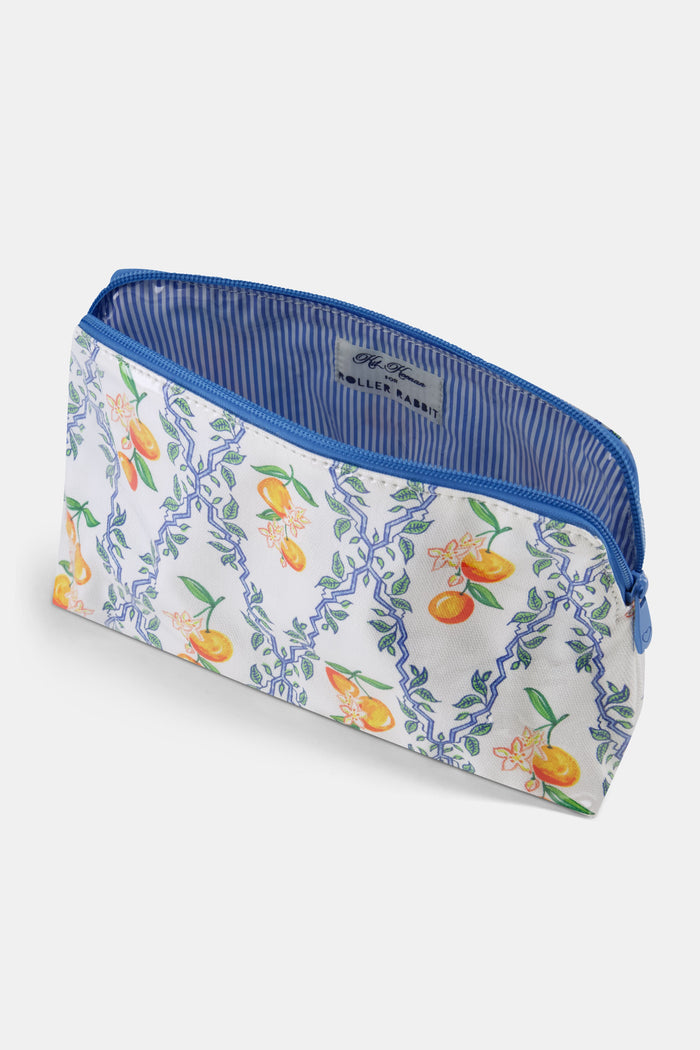The Clementine Trellis Makeup Bag by Roller Rabbit is a zippered, water-resistant cotton canvas bag with a blue zipper and a white background featuring blue geometric lines, green leaves, orange fruits, and white flowers.