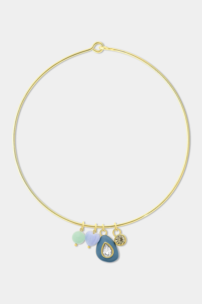 A woman wears a green cable-knit sweater and the Roller Rabbit Collar Stone Necklace, which features multiple colorful charms, including a blue pendant and beads. Only her lower face, neck, and upper chest are visible.