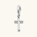 Silver open-cut cross charm pendant with a spring-ring clasp, shown on a white background.