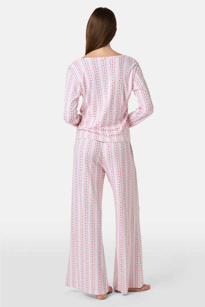 The Daisy Heart Stripe Boden Pant by Roller Rabbit features a wide-leg silhouette with a white base, adorned with vertical pink floral and dotted stripes. Designed for comfort, these pajama pants have an elastic waistband and are crafted from soft Pima cotton for a luxurious feel.