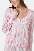 A woman smiles while wearing the Roller Rabbit Daisy Heart Stripe Jessie Long Sleeve Tee, a soft Pima cotton top adorned with pink and red daisies, paired with matching pajama bottoms, against a plain white background.