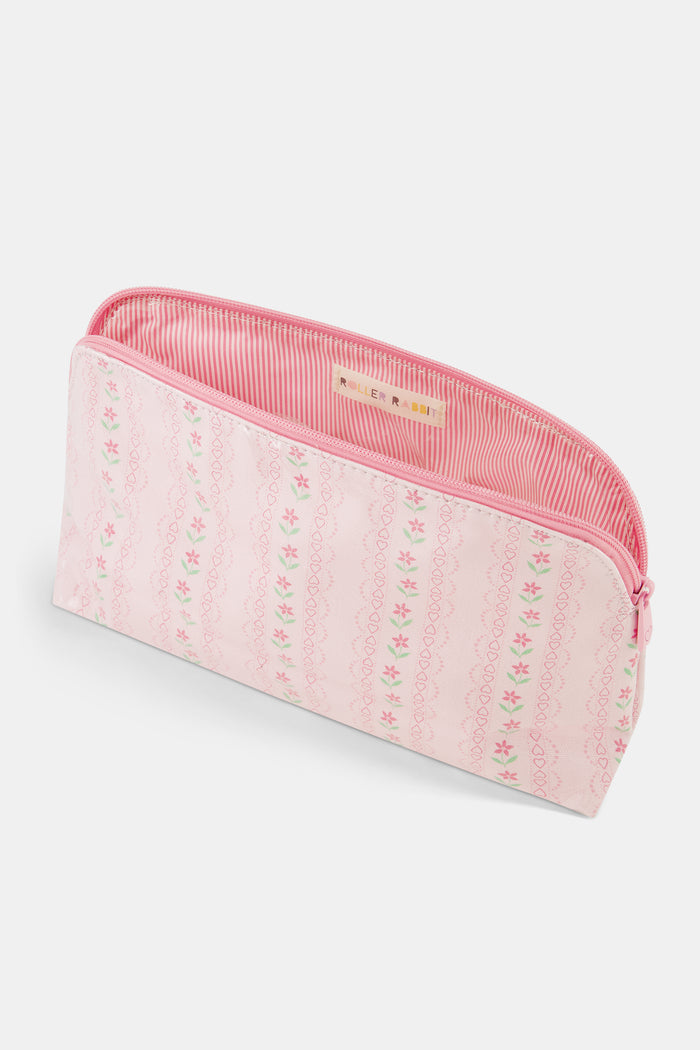 The Daisy Heart Stripe Makeup Bag by Roller Rabbit is a pink cotton canvas cosmetic pouch with a zipper, adorned with a delicate pattern of pink lines and small green and pink floral motifs on a light background.
