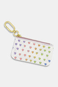 Keep essentials secure with the Roller Rabbit Disco Hearts Coin Pouch—a small white cotton canvas pouch featuring a gold clip and a colorful, hand-drawn heart pattern. Water-resistant for everyday use.