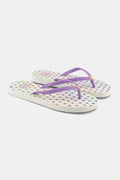 Roller Rabbit's Disco Hearts Flip Flops feature a colorful heart pattern and light purple straps, making them the perfect vacation footwear. Shown here against a plain white background.
