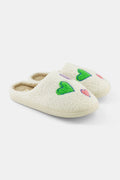 The Roller Rabbit Disco Hearts Fuzzy Slippers are white shearling slippers featuring green and pink heart designs, shown on a plain white background.