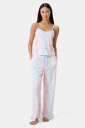 A woman stands barefoot wearing the Roller Rabbit Disco Monkey Lily Set, a matching Pima cotton pajama set featuring a pastel lace-like pattern, sleeveless camisole top, and drawstring pants with pockets.