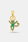 The Enamel Monkey Charm by MADISON 501 features a smiling face and curly tail in green enamel on 14K gold covered brass, making playful holiday jewelry. Shown on a plain white background.