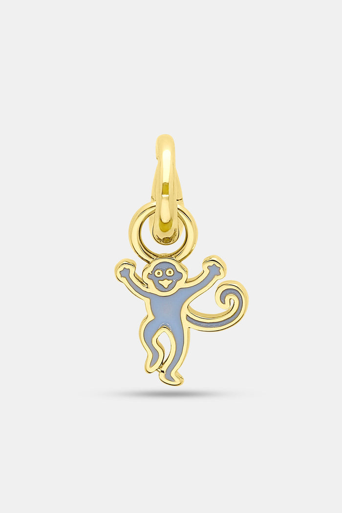 The Roller Rabbit Enamel Monkey Charm features a smiling gold and light blue cartoon monkey with raised arms and a curled tail, attached to a gold-covered brass clasp.