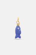 The Roller Rabbit Fish Charm features a small blue enamel fish with a sparkling stone eye, hanging from a gold-colored loop and bail, displayed on a plain light background.