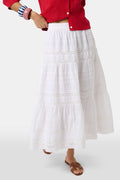 A person wears a red cardigan, the Florence Lace Carlisa Skirt by Roller Rabbit, brown slide sandals, and red, white, and blue bangle bracelets against a plain white background.