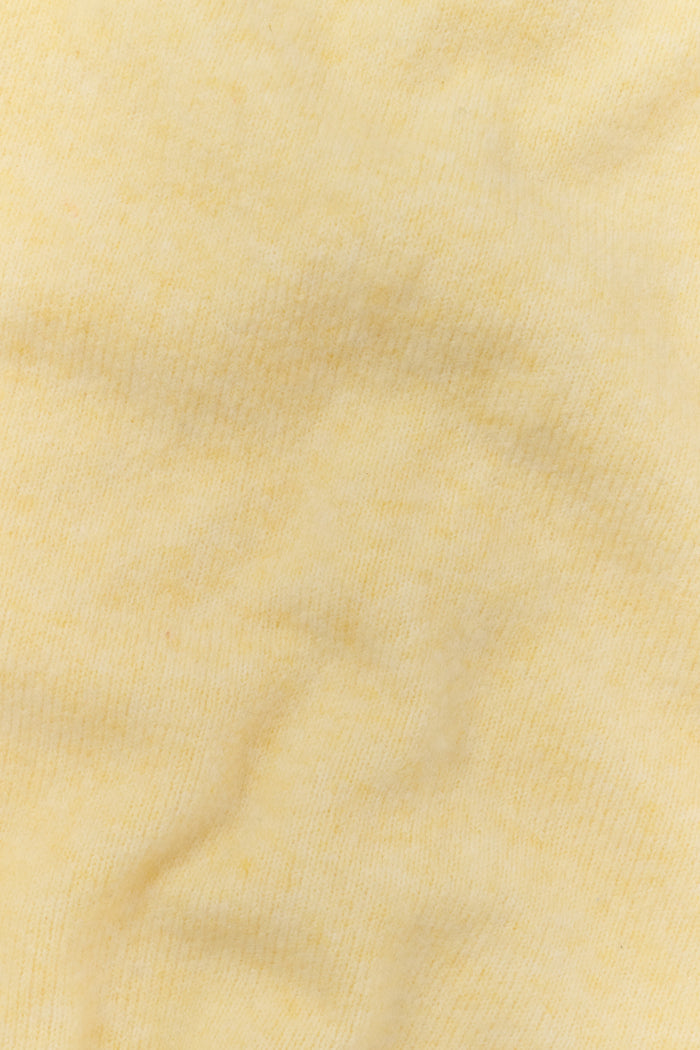 A person wearing the Roller Rabbit Gaia Pant paired with a light yellow knit sweater and beige slippers stands against a plain white background.