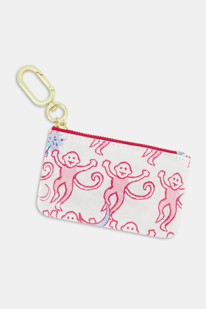 Introducing the Roller Rabbit Gamma Phi Beta Monkey Coin Pouch—a compact white zippered pouch crafted from water-resistant cotton canvas, adorned with playful pink cartoon monkeys and finished with a gold keychain clip at the corner. Designed for easy cleaning.