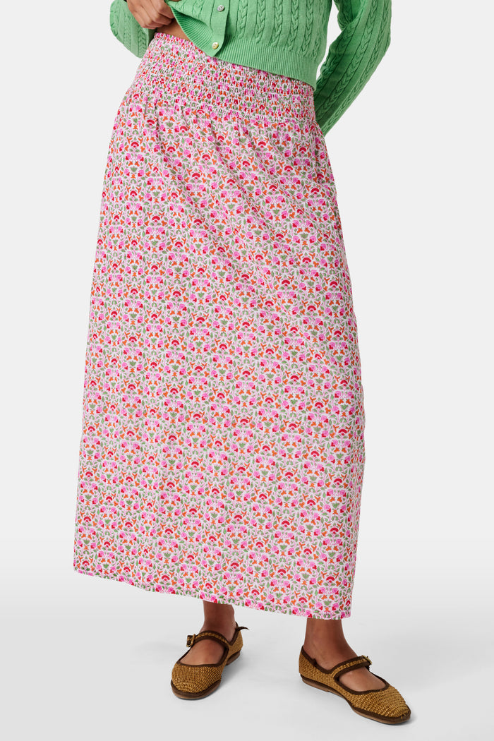 A Roller Rabbit Kids Garden Gate Floral Alexis Skirt with matching briefs, both showcasing a pink, green, and white flower pattern, is displayed on a plain white background. This cotton skirt is ideal for girls who love playful floral prints.