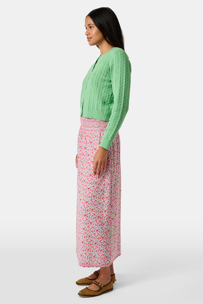 A Roller Rabbit Kids Garden Gate Floral Alexis Skirt with matching briefs, both showcasing a pink, green, and white flower pattern, is displayed on a plain white background. This cotton skirt is ideal for girls who love playful floral prints.