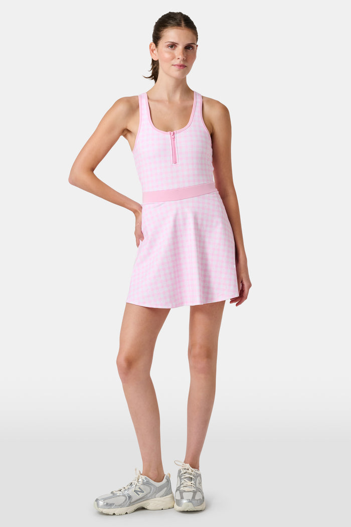 The Roller Rabbit Gingham Hearts Becky Active Dress is a sleeveless pink gingham dress featuring a fitted bodice, zipper front, and flared skirt, crafted from soft peached interlock fabric and shown on a plain white background.