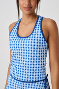 A person wears the Roller Rabbit Gingham Hearts Bella Tank, a blue-and-white checkered racerback style with small heart details. The image is cropped at the shoulders and midsection, showing part of the matching skirt and the person’s head.