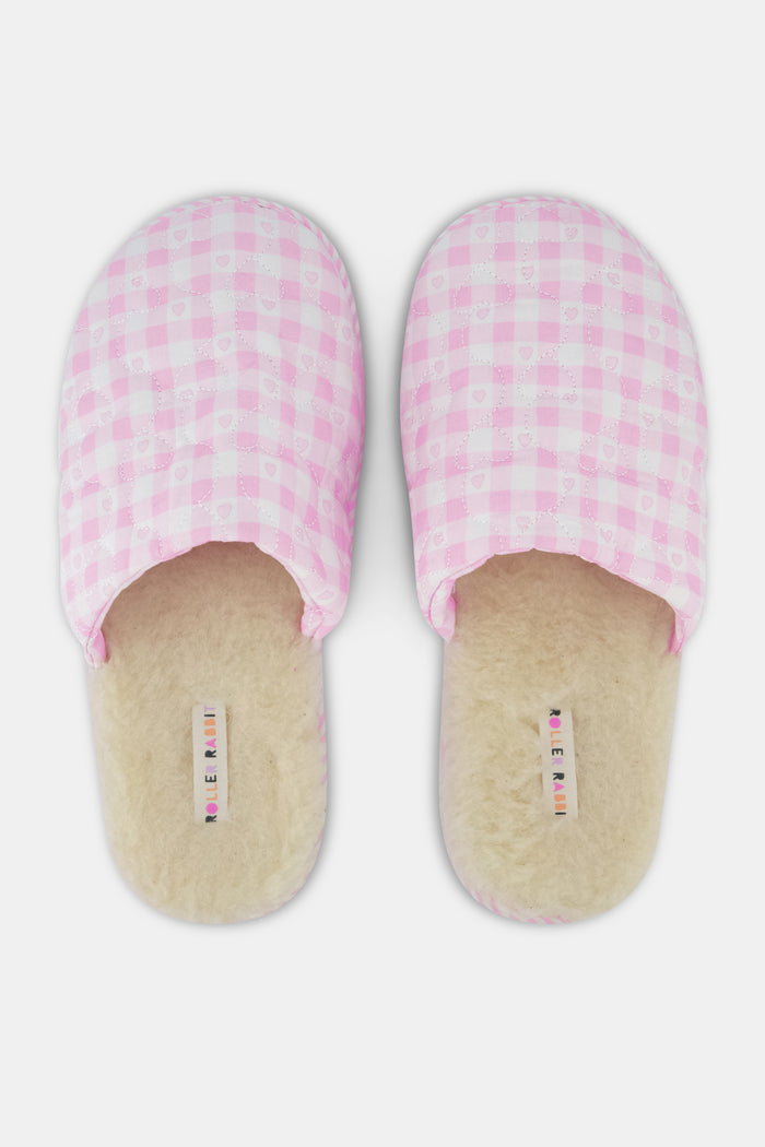 A pair of Roller Rabbit Gingham Hearts Quilted Slippers in pink and white, featuring closed toes and open heels, is displayed on a white background.