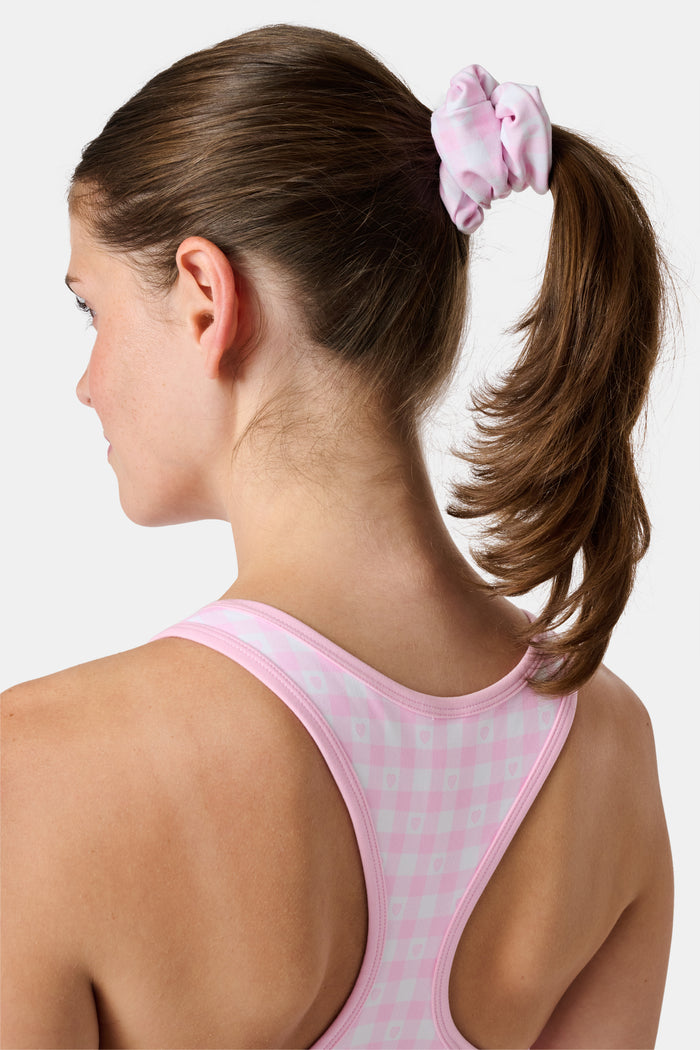 The Roller Rabbit Gingham Hearts Scrunchie Set Of 2 features one pink and white gingham scrunchie with small hearts and one blue and white gingham scrunchie with small hearts, displayed vertically on a plain background.