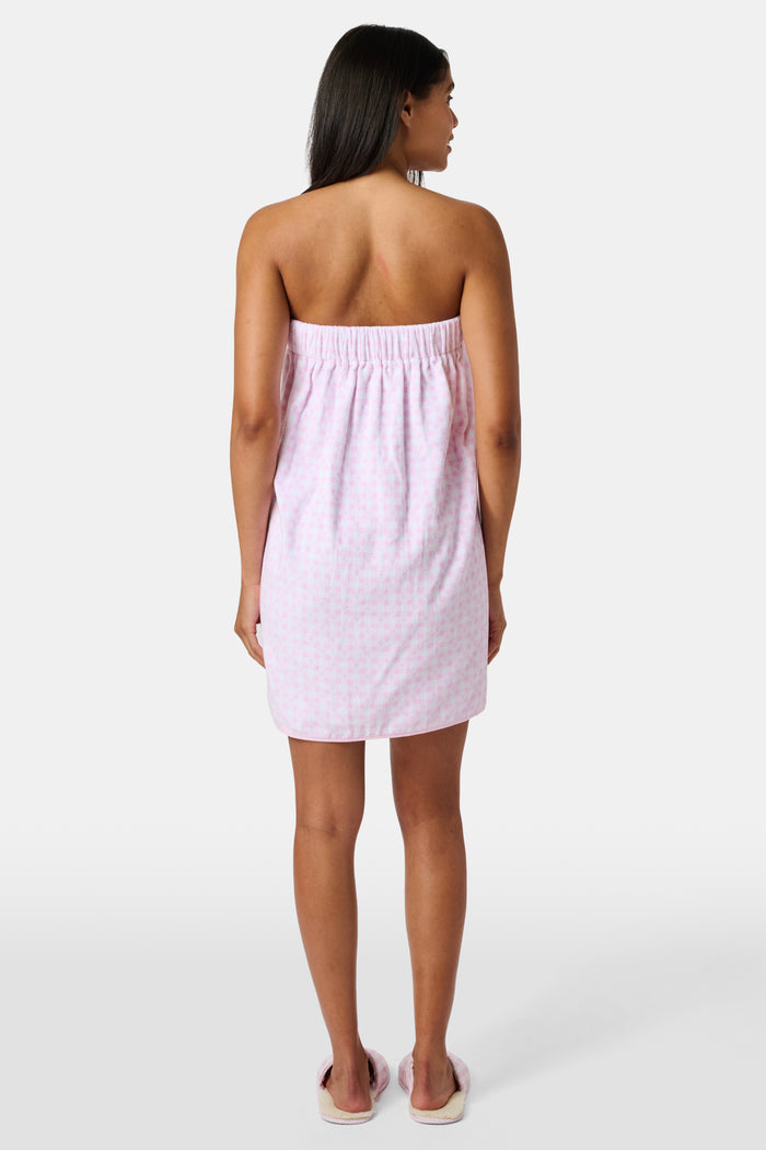 The Roller Rabbit Gingham Hearts Spa Headband is crafted from 100 cotton terrycloth and showcases a pink and white checkered pattern accented with small hearts. It features a convenient hook-and-loop fastener and is displayed laid flat on a white background.