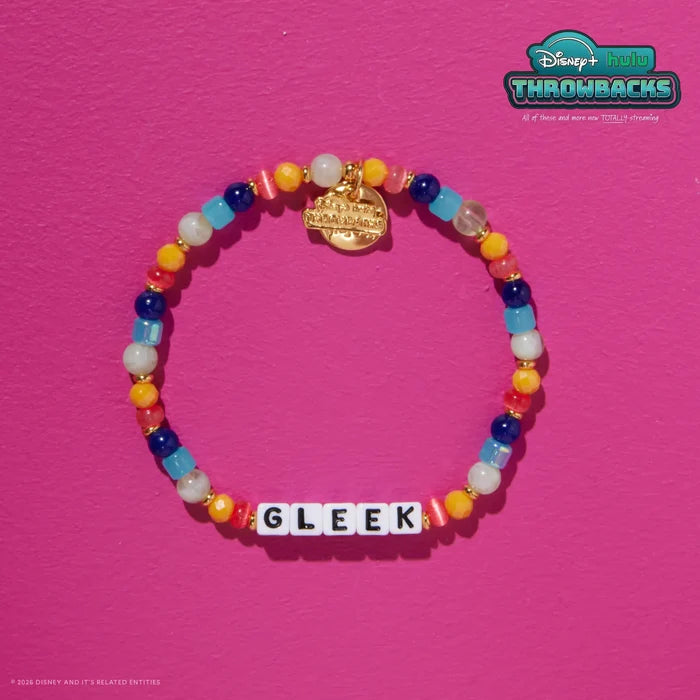 Gleek Disney+ Hulu Throwbacks bracelet on a hot pink background showing the gold Throwbacks logo tag