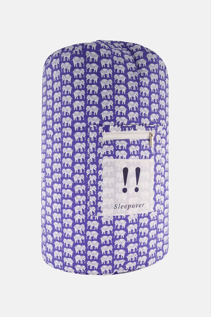The Hathi Sleepover Bag by Roller Rabbit is a cylindrical purple kids’ sleeping bag featuring a white elephant pattern, front zippered pocket, and “!! Sleepover” label. The photo shows the bag on a plain white background.