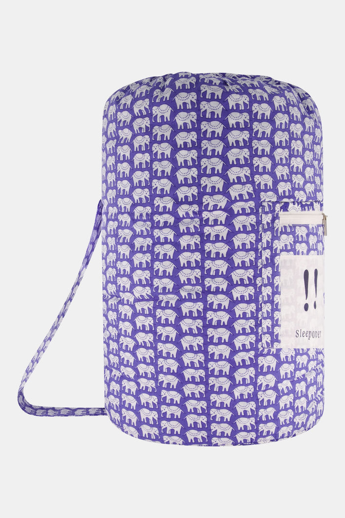 The Hathi Sleepover Bag by Roller Rabbit is a cylindrical purple kids’ sleeping bag featuring a white elephant pattern, front zippered pocket, and “!! Sleepover” label. The photo shows the bag on a plain white background.