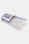 The Hearts Baby Quilt by Roller Rabbit is a folded white cotton quilt with blue and purple geometric borders, adorned with small heart prints—perfect for baby bedding.