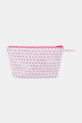 The Hearts Toiletry Case by Roller Rabbit is a white, water-resistant zip pouch with a pink zipper and handle, adorned with small pink hearts—perfect for organizing your travel essentials.