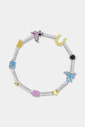 The Icon Party Beaded Bracelet by Roller Rabbit features a beaded silver chain adorned with colorful charms—including a pink monkey, blue elephant, yellow horseshoe, star, moon, and a blue eye—set against a white background.