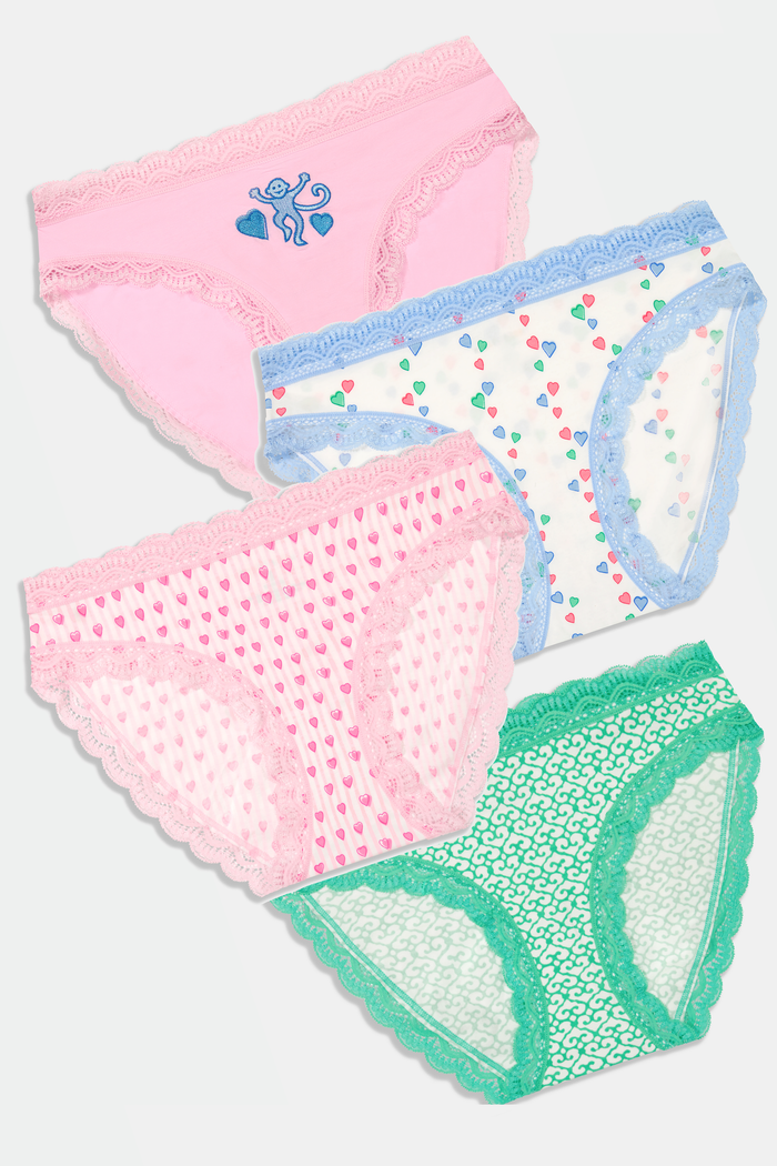 Roller Rabbit Icons Bikini 4 Pack features four girls' panties: solid pink with butterfly, white with colorful dots and blue trim, pink with hearts, and green geometric modal with lace trim.