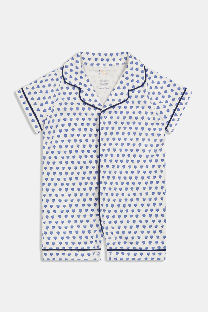 The Infant Hearts Polo Onesie by Roller Rabbit features a blue heart print, navy piping, a button-up front, and classic collar—offering a look inspired by playful blue heart rompers.
