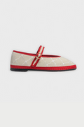 The Jena Embroidery Pierre by FLABELUS is a beige Mary Jane shoe, handmade in Spain, with a white pattern, red trim, a red strap and gold buckle, plus a black sole.