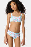 A young girl with curly hair wears the Roller Rabbit Kids 4th Of Jemina/Starry Dot Cora Bikini. She stands against a plain light gray background, looking at the camera with a slight smile.