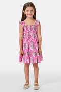 The Kids Ava Floral Ceri Dress by Roller Rabbit is a sleeveless baby dress featuring a smocked bodice and ruffled straps, adorned with green and white leaf patterns on a vibrant pink background, and comes with matching bloomers.