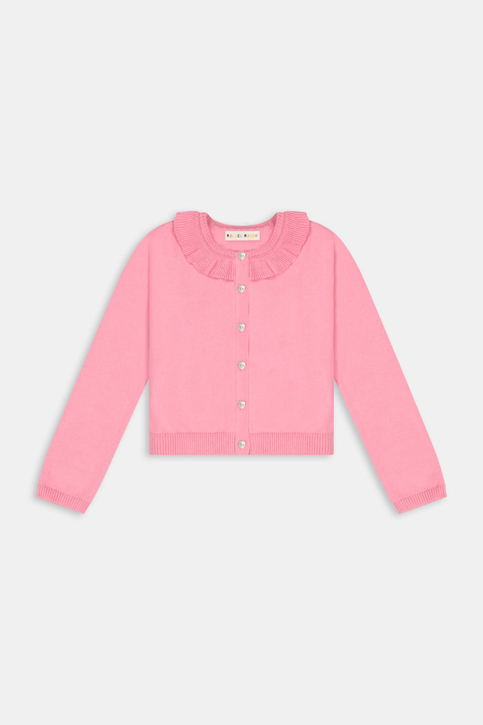 The Kids Ellis Cardigan by Roller Rabbit is a rose pink, long-sleeve cardigan featuring a ruffled collar and pearl-like buttons. Shown flat on a white background, it's made from soft cotton sweater material.