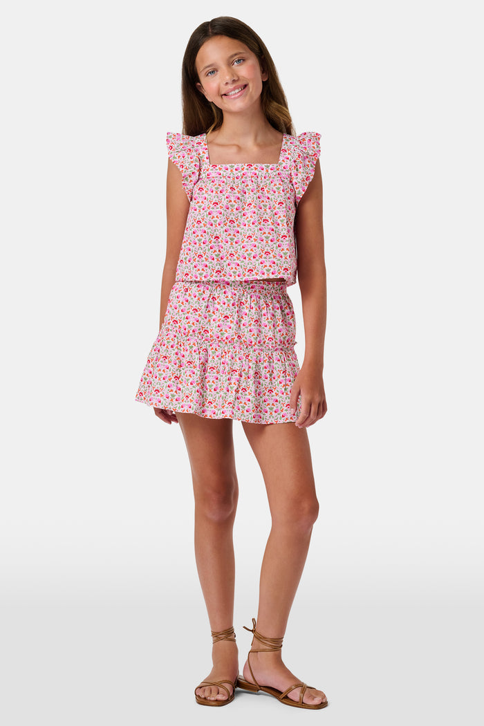A Roller Rabbit Kids Garden Gate Floral Alexis Skirt with matching briefs, both showcasing a pink, green, and white flower pattern, is displayed on a plain white background. This cotton skirt is ideal for girls who love playful floral prints.