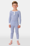 A young boy stands barefoot, smiling in Roller Rabbit Kids Hathi Pajamas—a matching Pima Cotton set with blue elephant print and white cuffs—against a plain white background.