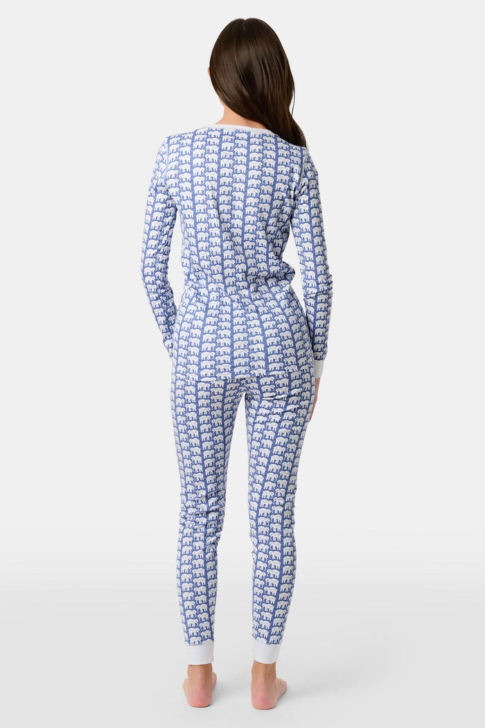 A young boy stands barefoot, smiling in Roller Rabbit Kids Hathi Pajamas—a matching Pima Cotton set with blue elephant print and white cuffs—against a plain white background.
