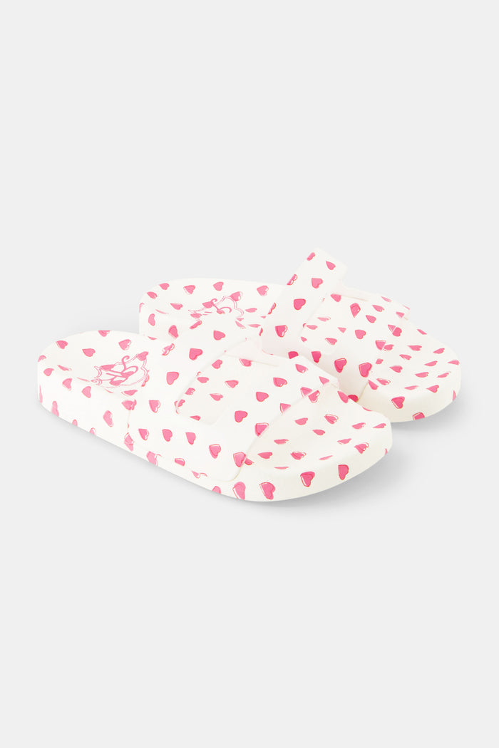 A pair of Kids Hearts Pool Slides by Roller Rabbit featuring an all-over pink heart pattern on a white background.