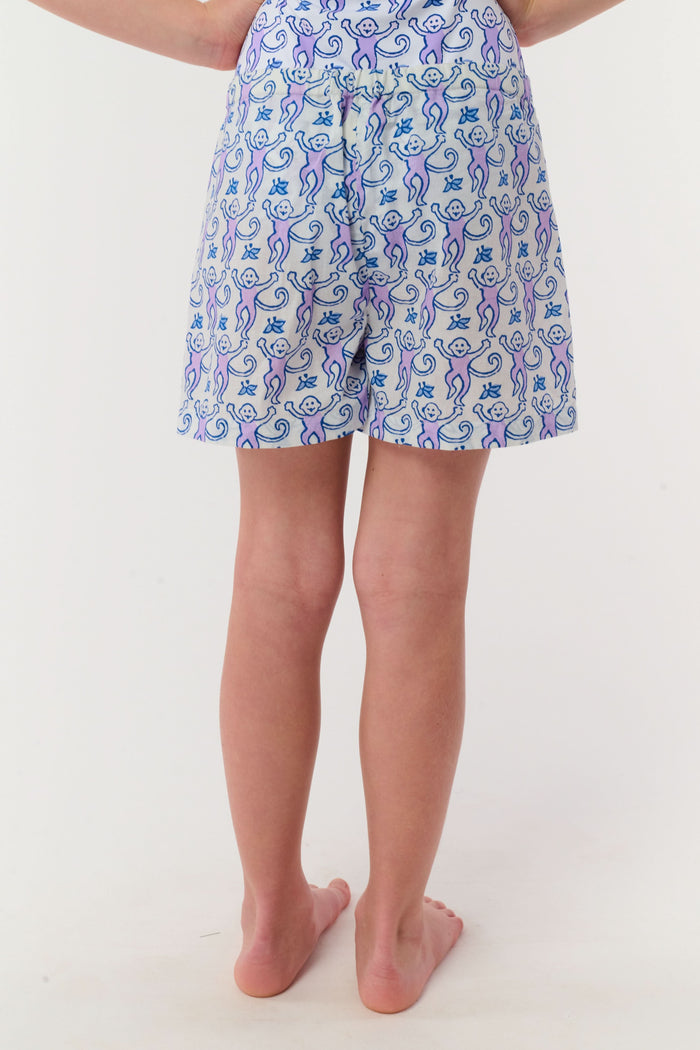 A child models the Roller Rabbit Kids Monkey Lounge Short—a matching pajama set with a blue and purple monkey print, sleeveless top, and cambric shorts with a purple drawstring—against a plain white background.